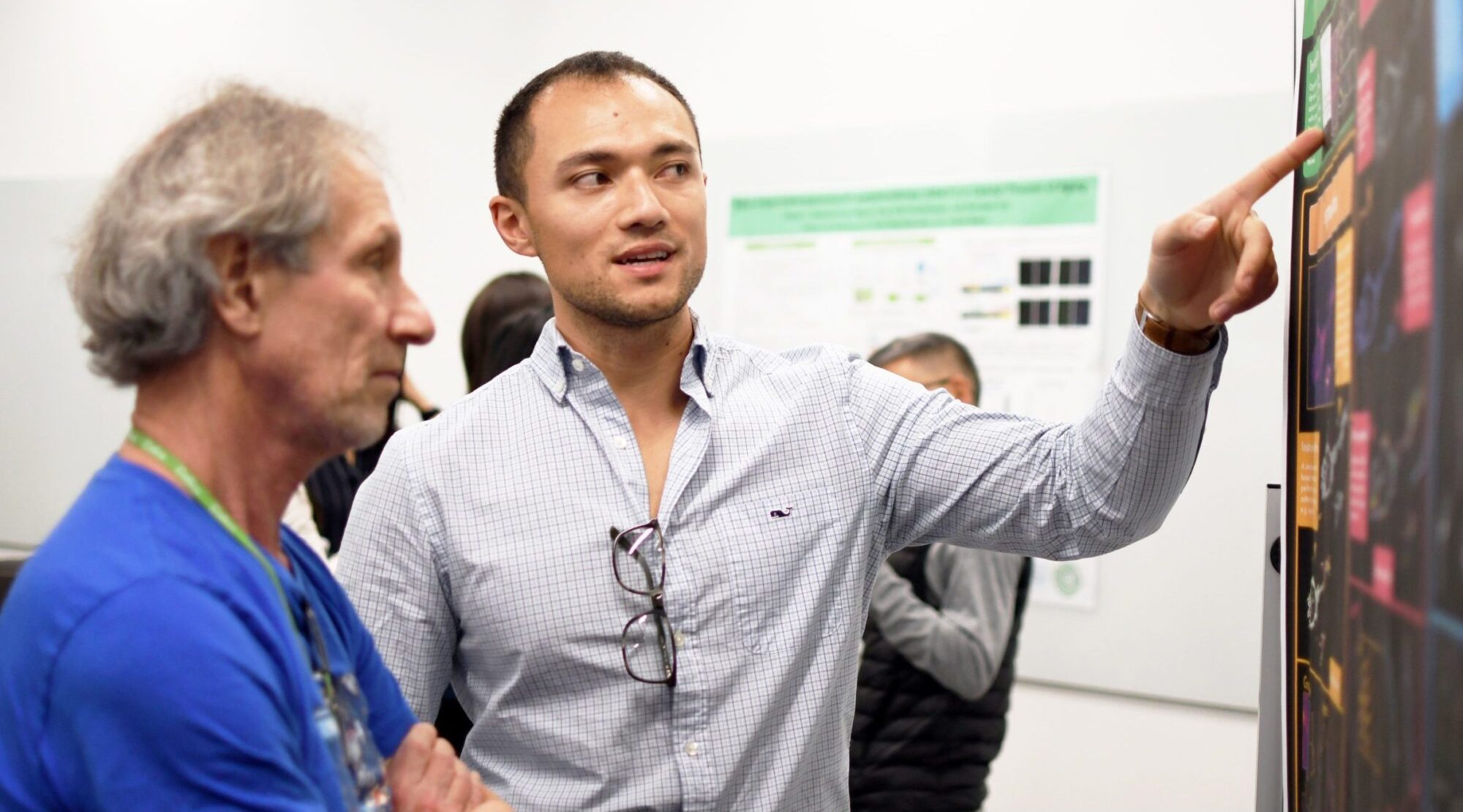 Colleages discuss poster session